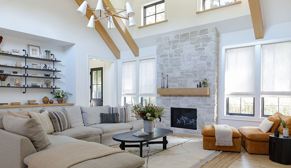 Window shades in a chalet-inspired room include Flat Roman Shades made of Sheer Wool Blend in Cloud for a light, breezy look