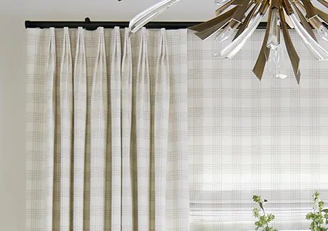 A close up of shades and drapery made of Emerson material in Shea shows an ideal pattern for farmhouse window treatments