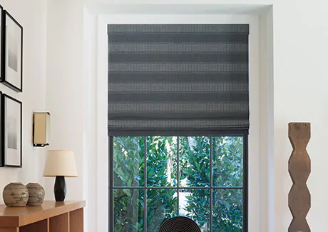 A contemporary space features privacy shades in a Flat Roman Shade style made of Victoria Hagan's Jasmine in bold Midnight