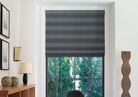 Window shades in a modern room include Flat Roman Shades made of Victoria Hagan Jasmine in Midnight for a bold look