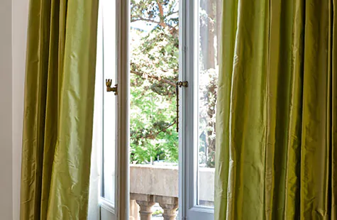 French door window treatments include Goble Drapery in Silk Dupioni Leaf on traditional French doors with the latch opened