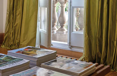 Window treatment trends 2023 include luxurious details like puddle length drapey with fabric spilling onto the floor