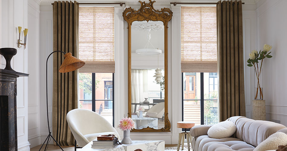Grommet drapery in a brown color shows one type of drapery pleat styles in an ornately living room with tall windows