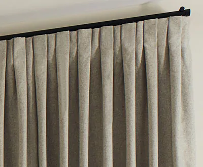 A close up of Inverted Pleat Drapery panels made of Wool Blend in Fleece shows the flat, crisp pleats for a stately look