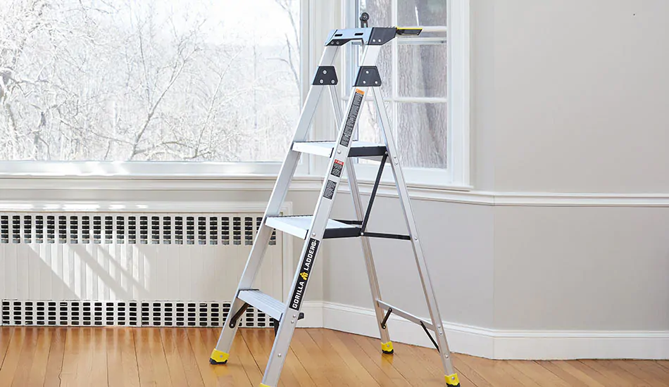 A step ladder sits in front of a bay window in preparation for the first step of how to measure for curtains
