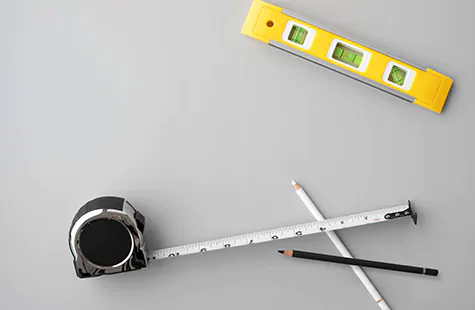 The first step for installing vertical blinds is to gather tools like a tape measure, level and pencils
