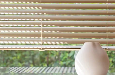2 inch metal blinds made of aluminum in a gold champagne color are a chic modern option for bay window blinds