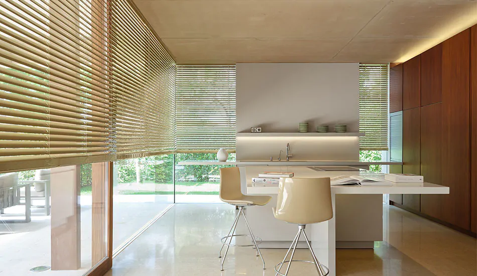 Metal Blinds made of 2-inch Champagne are used as cat proof blinds in a modern kitchen with floor-to-ceiling windows