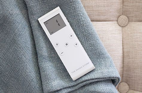 A remote on fabric representing the device needed to adjust solar shades for windows from anywhere in the home