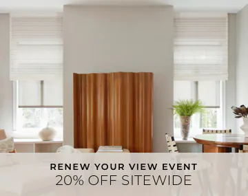 Motorized Roman and Roller Shades hang in a family room with wood decor with overlaid sales messaging for 20% off sitewide