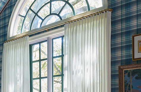 French return curtain rods like Lafayette in Satin Brass offer refined style with Pinch Pleat Drapery in a blue bedroom
