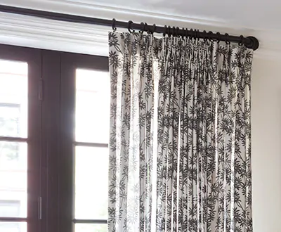 Boho curtains made of Pinch Pleat Drapery of Daisy Bloom in Zebra Black add visual dimension to a tall window and door