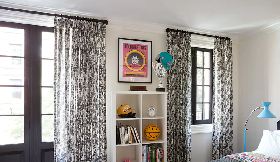 Kids curtains made of Daisy Bloom in Zebra Black add black and white contrast to the windows in an older child's room
