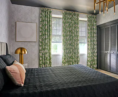 A room designed by Rasheeda Gray at the 2022 Kaleidoscope Showhouse has earthy green drapery made with Family of Cranes