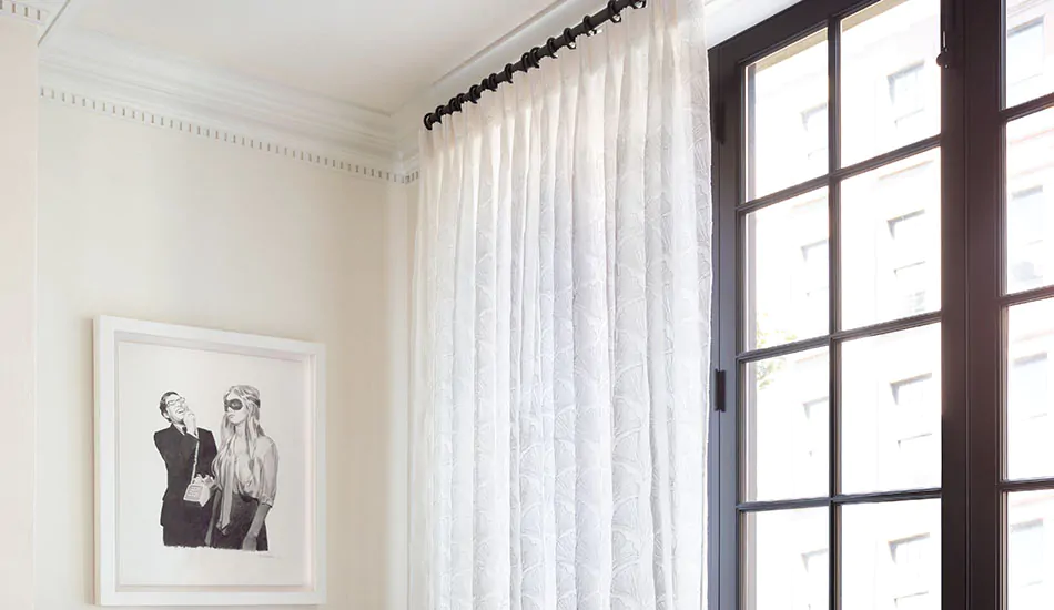 A sitting room shows modern curtain ideas in its Pinch Pleat Drapery made of sheer Feather Palm Embroidery in Vintage Lace