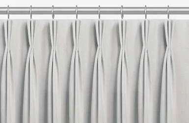One example of drapery styles is showcased in a product image of pinch pleat drapery with its three-fingered pleat