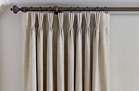A close up of Pinch Pleat Drapery made of Shoreline in Reed shows the three finger pleats of this style of window coverings