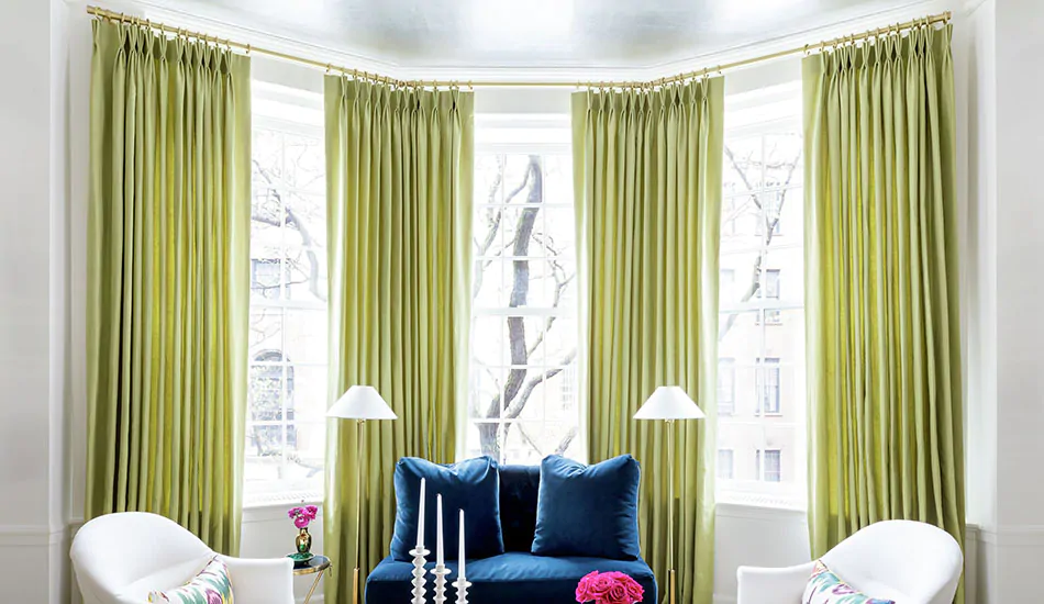 Window treatments for bay windows include Pinch Pleat Drapery made of Silk Dupioni in Leaf for an inviting bright green color