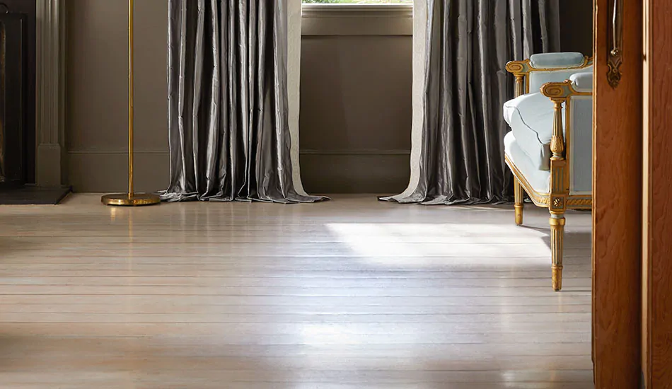 Light wood flooring under a window with drapery in Silk Dupioni, Pewter, shows how to brighten a dark room with light floors