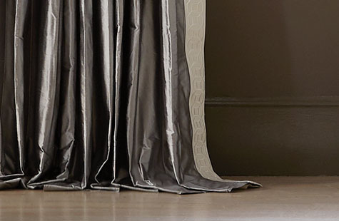 Pinch Pleat Drapery made of Silk Dupioni in Pewter puddles on the floor showing how to hang curtains at puddle length