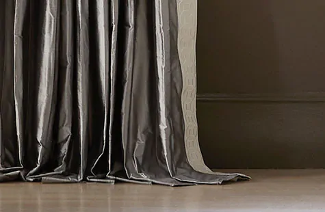 Pinch Pleat Drapery made of Silk Dupioni in Pewter puddles on the floor showing how to hang curtains at puddle length