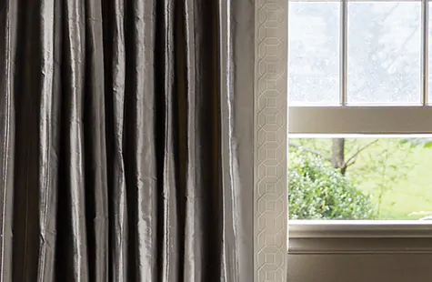 A close up silk curtains made of Silk Dupioni in Pewter shows the soft luster and delicate look of silk drapes