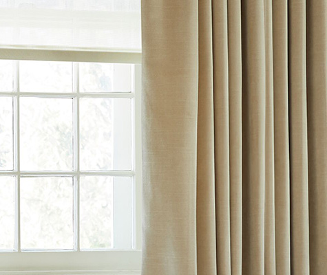 A close up of velvet curtains made of Velvet in Cream with lining shows the additional privacy and light control achieved