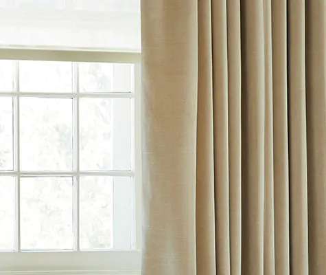 A close up of velvet curtains made of Velvet in Cream with lining shows the additional privacy and light control achieved