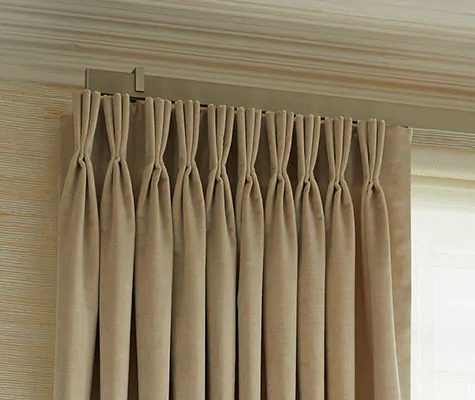 A close up of Pinch Pleat velvet curtains made of Velvet in Cream shows the elegant aesthetic of the pleat style