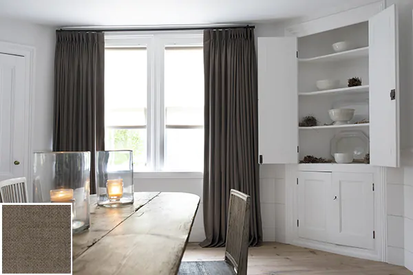 Colorful curtains made of Wool Flannel in Walnut add warmth to a bright rustic kitchen with a wood table