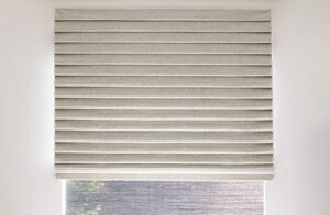 Window shades in a modern sitting room include Pleated Roman Shades made of Wool Blend in Fleece for a luxe look