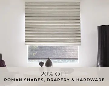 Pleated Roman Shade covers a large window in a room with a white table and black vase with overlaid sales messaging