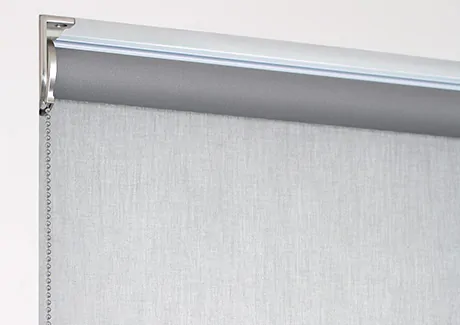 A product image of a regular roll roller shade shows the material falling off the back of the tube closer to the window