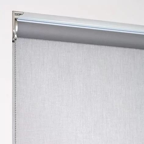 A product image of a roller shade with a regular roll, with material falling off the back of the tube