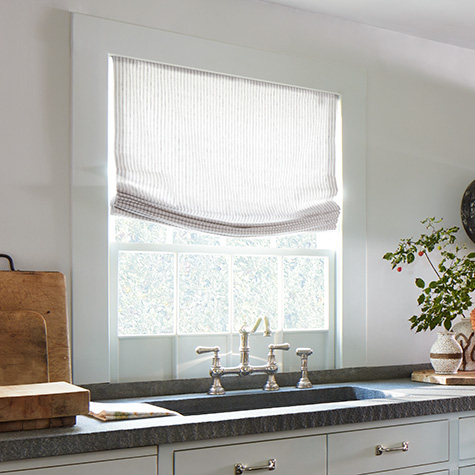 Roman Shades for kitchen windows include Relaxed Roman Shades made of Windsor Stripe in Sage in a Coastal style kitchen