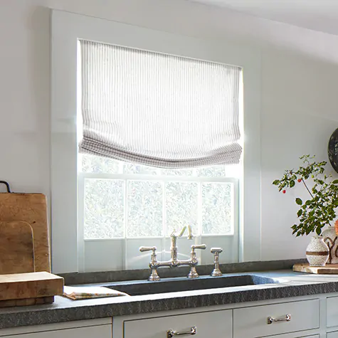 Roman Shades for kitchen windows include Relaxed Roman Shades made of Windsor Stripe in Sage in a Coastal style kitchen