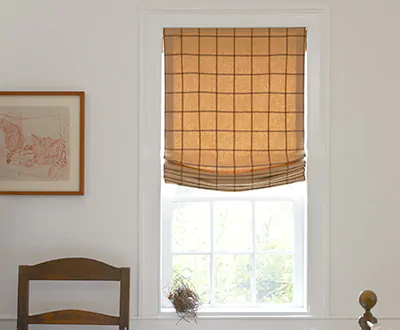 An alternative to basement window curtains includes Relaxed Roman Shades made of Highland in Sandstone