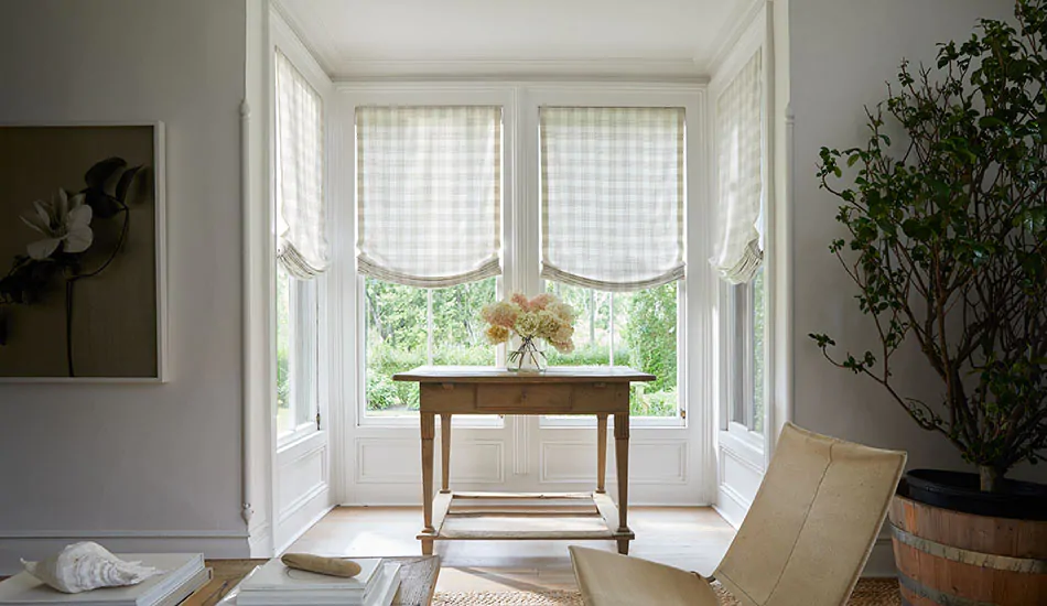 Relaxed Roman Shades made of Holland and Sherry Emerson material in Shea lend warmth and texture to a nook