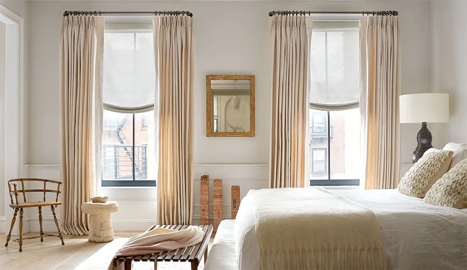 Hygge-inspired coziness created by soft textures, wood tones and warm neutrals like in this bedroom are on trend for 2023