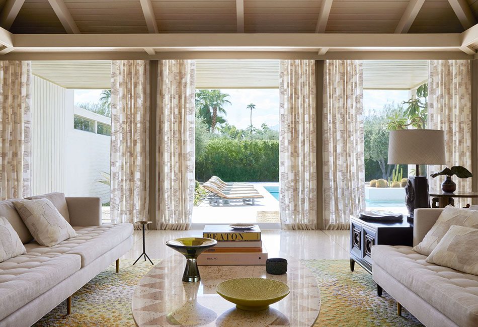 Living room curtain ideas for a modern boho transitional space includes drapes on doors that lead to a pool
