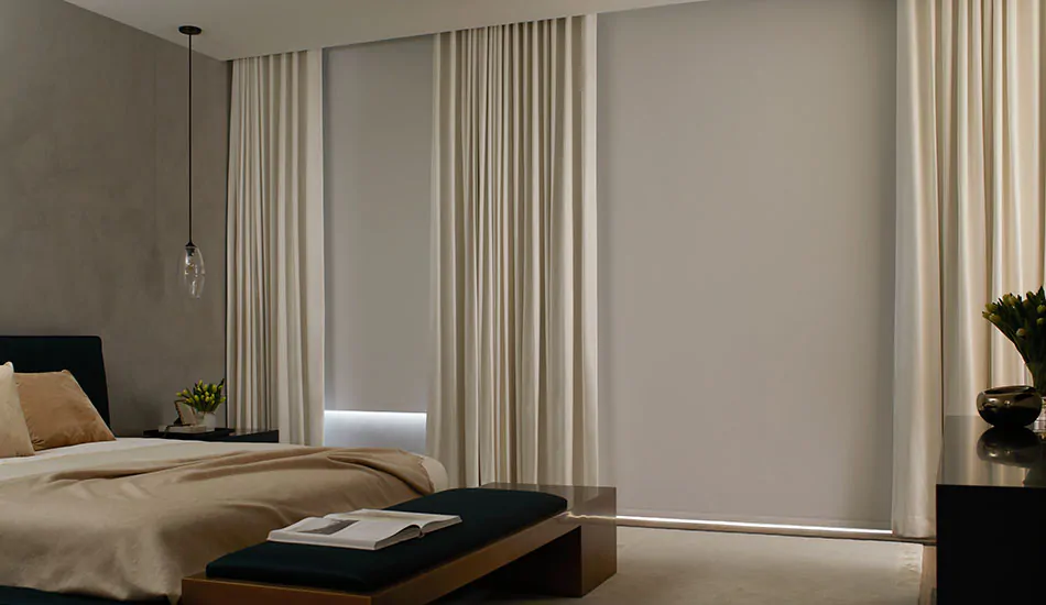 A window treatment buying guide helps you pick based on feature like Blackout Roller Shades and Drapery in a bedroom