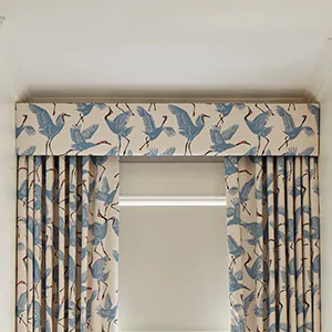 A drapery cornice made of Family of Cranes in Waverly Blue covers the top of kids curtains for a better blackout effect