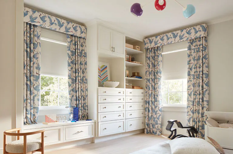 A child's bedroom features kids curtains made of Family of Cranes in Waverly Blue for a playful, vibrant look