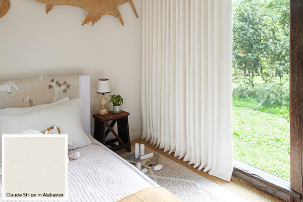Kids curtains in an off-white bedroom are made of Claude Stripe in Alabaster for visual and tactile softness