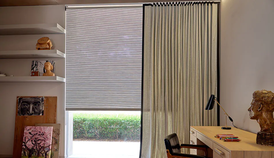 A modern office with mid-century modern decor features ripple fold drapery made of Wool Blend in Ash with a dark tape border
