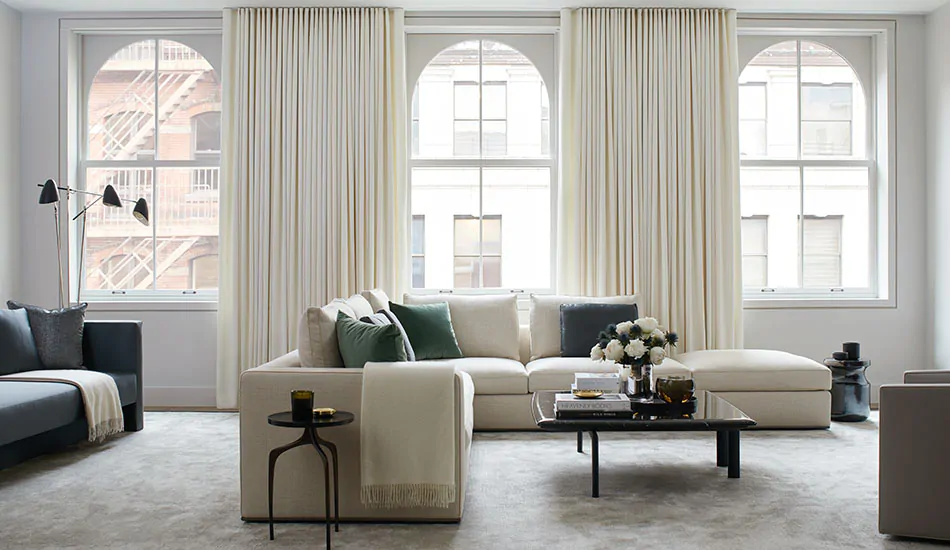 Neutral curtains made of Wool Flannel in Glacier add warmth with their color and soft texture to a modern living room