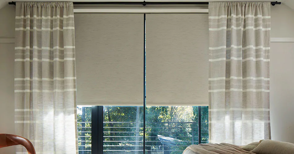 Rod pocket drapery in a neutral color with a stripe pattern shows one type of drapery pleat styles in a casual room