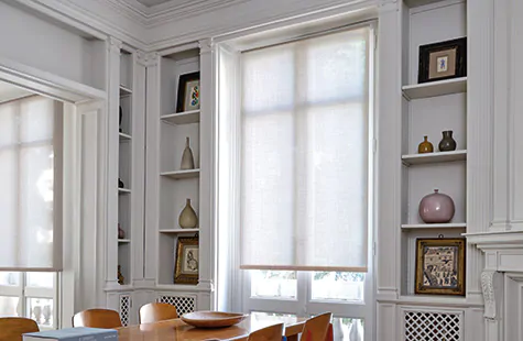 A door window shade made of a Roller Shade in Chelsea, Sand covers French Doors in a mid-century modern dining room