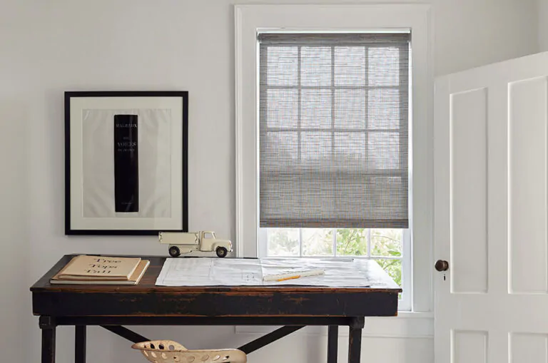 Pull down window shades in the Roller Shade style made of Jackson, Sand, adorn a window in a minimalist office with wood desk