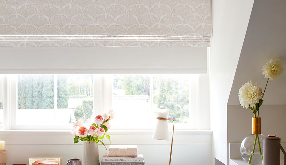 A Roller Shade is layered under a Roman Shade which emphasizes the differences between roller shades vs roman shades